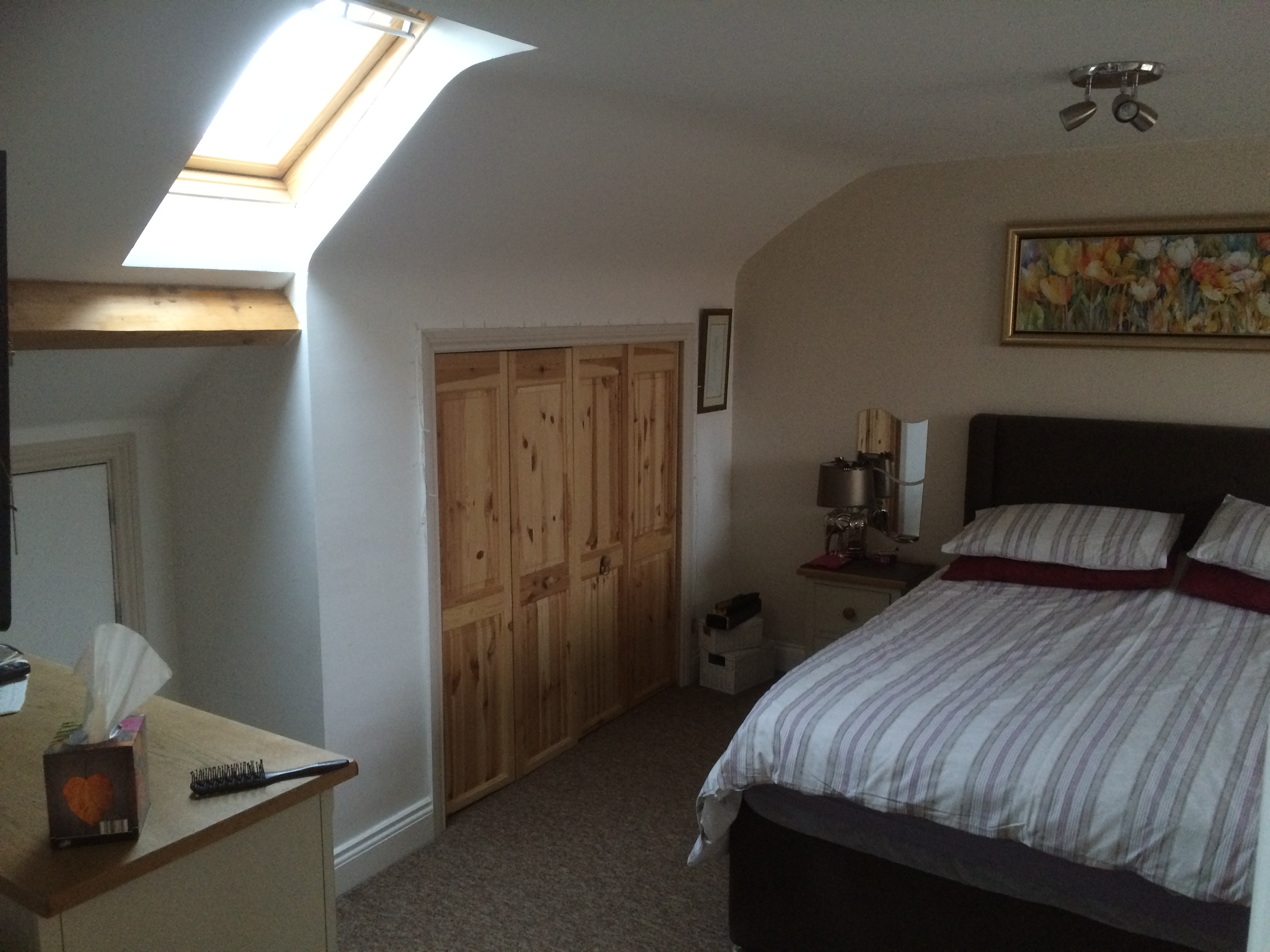 Bedroom loft conversion with built in storage and skylight